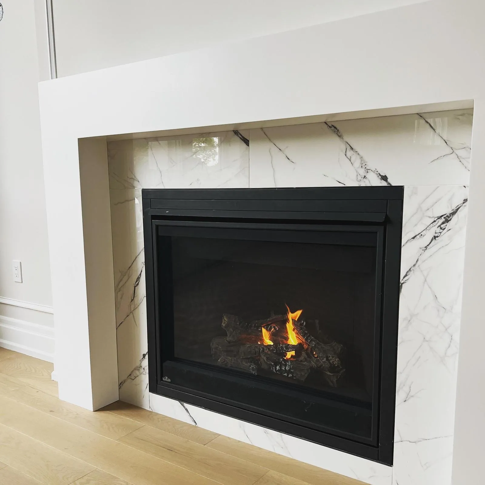 Classic black gas fireplace in a bright contemporary GTA room