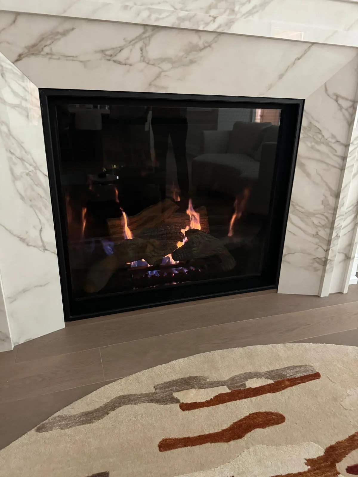 Stone-surround gas fireplace lit on a GTA install