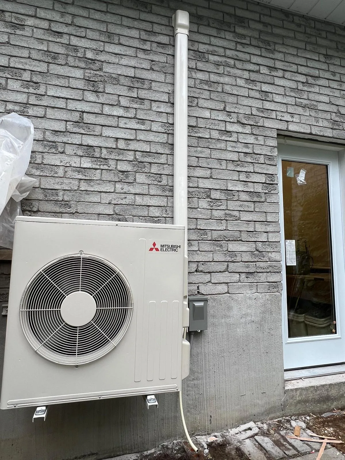 Mitsubishi cold-climate heat pump installed beside a Richmond Hill home